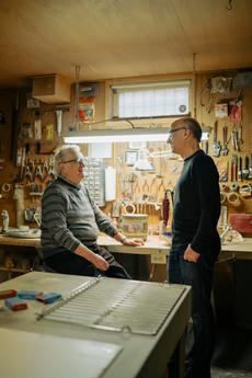 Julius Morry (left) with his son, Jeff, in his longtime basement workshop. (Photograph by Skye Spence)